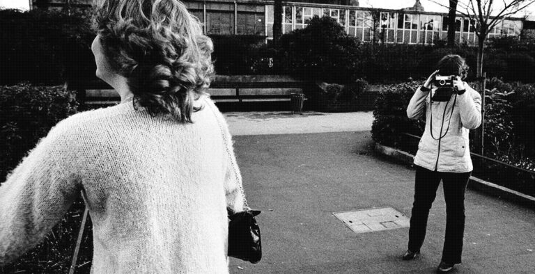 photo shows two women at the zoo with a camera